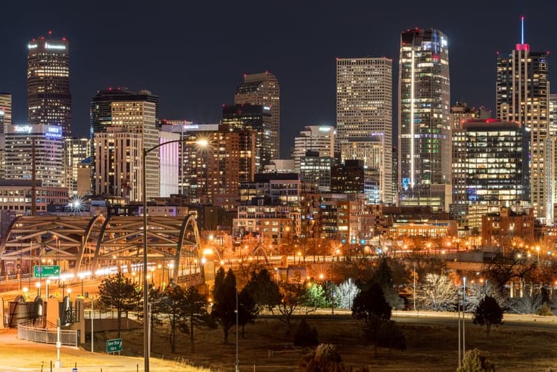 Wide panoramic view of the Milky Way arching over a mountain landscape