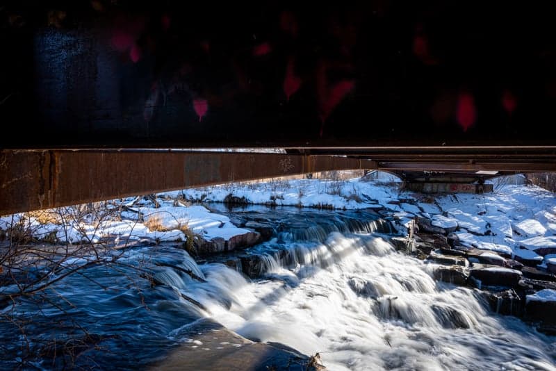 A frozen creek winding through a winter mountain valley
