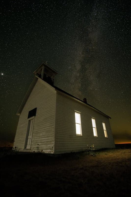 Stacked astrophotography image of the Milky Way rising above the landscape