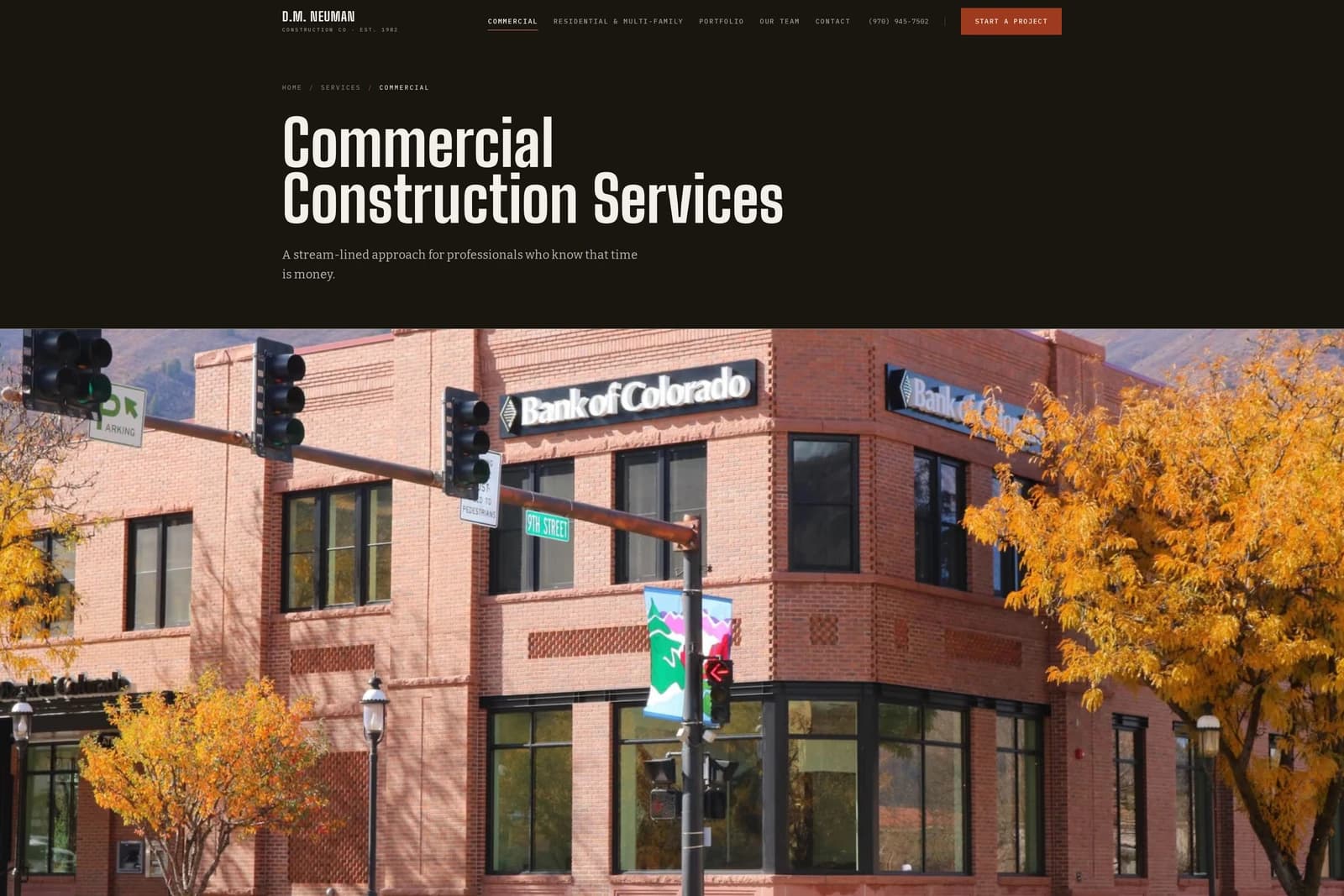 Commercial Construction Services — the Bank of Colorado building on a downtown Glenwood Springs corner in fall color.