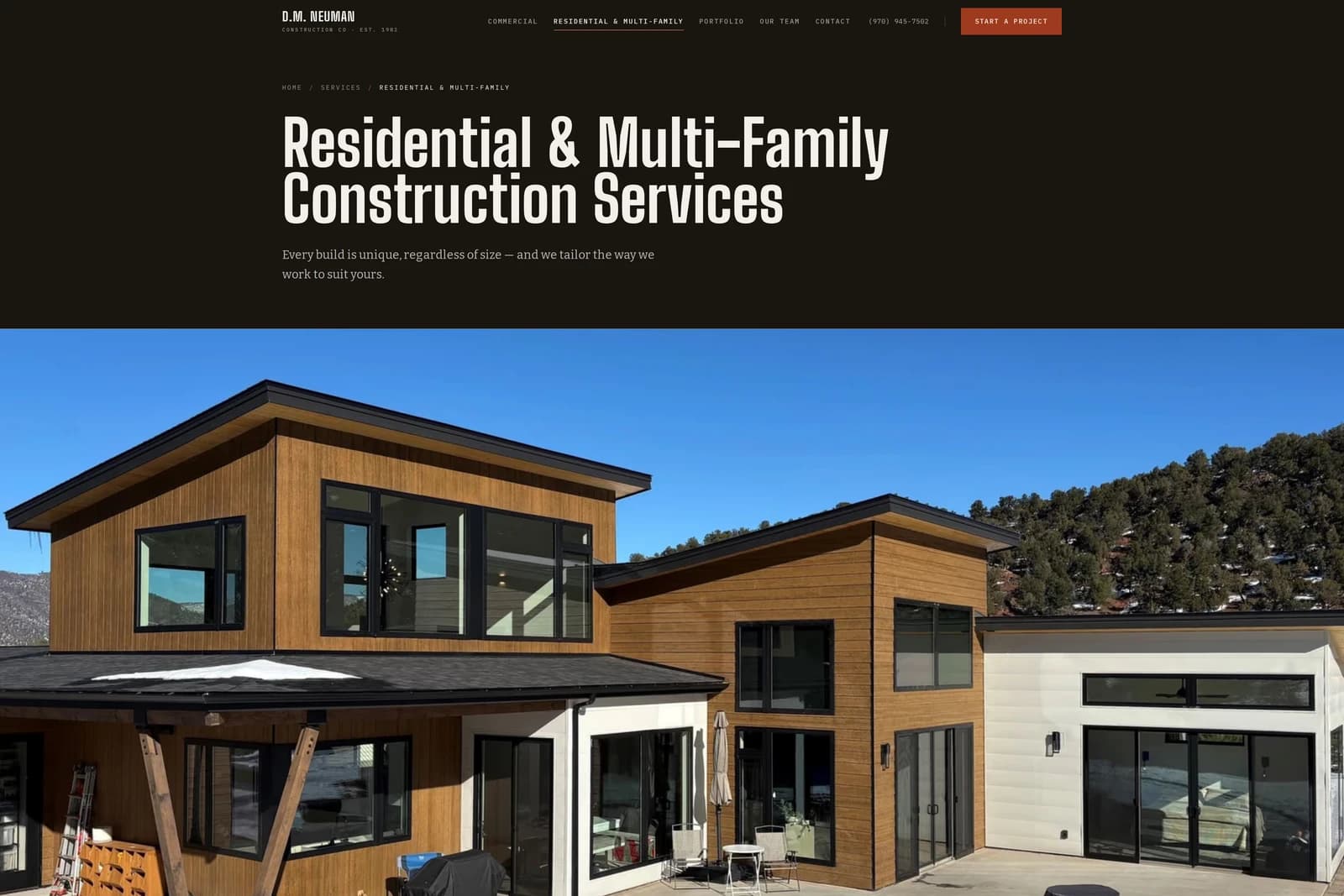 Residential & Multi-Family Construction Services — condensed white capitals over a wood-clad custom home under winter sun.