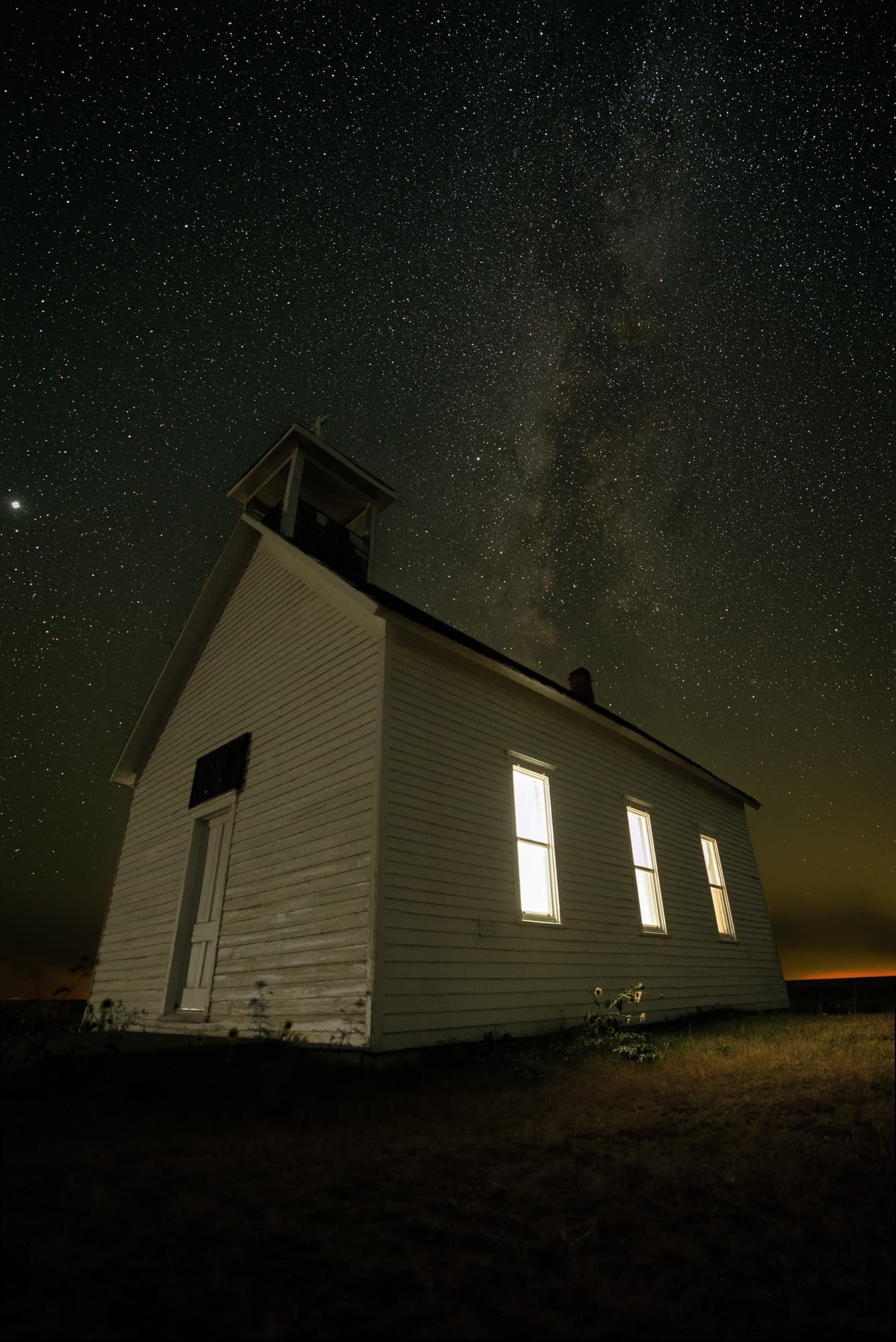 Stacked astrophotography image of the Milky Way rising above the landscape